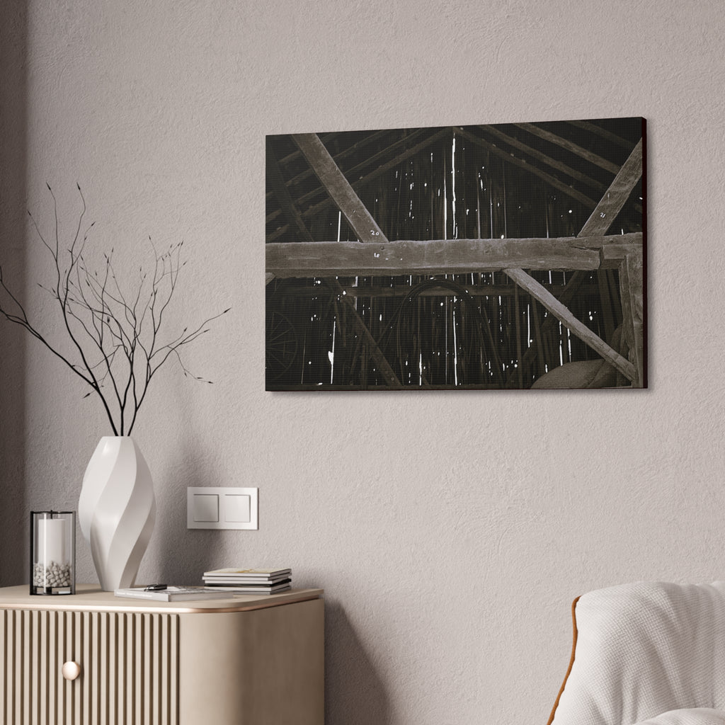 Rustic barn interior framed canvas print — moody looking-up view of weathered wooden beams and rafters with pinpoints of light, farmhouse photography wall art