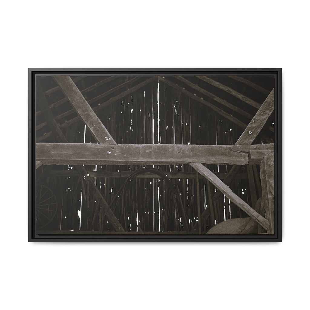 Rustic barn interior framed canvas print — moody looking-up view of weathered wooden beams and rafters with pinpoints of light, farmhouse photography wall art
