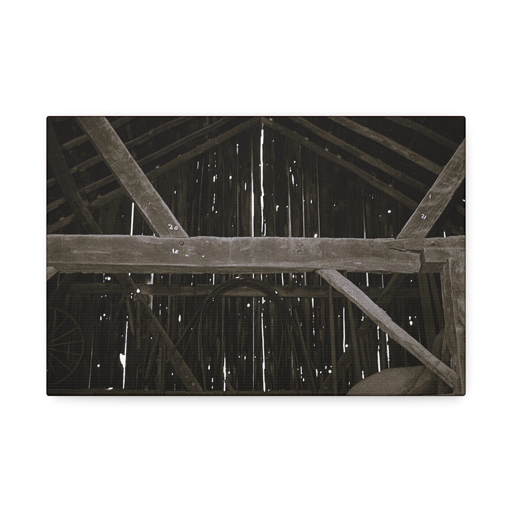 Rustic barn interior framed canvas print — moody looking-up view of weathered wooden beams and rafters with pinpoints of light, farmhouse photography wall art