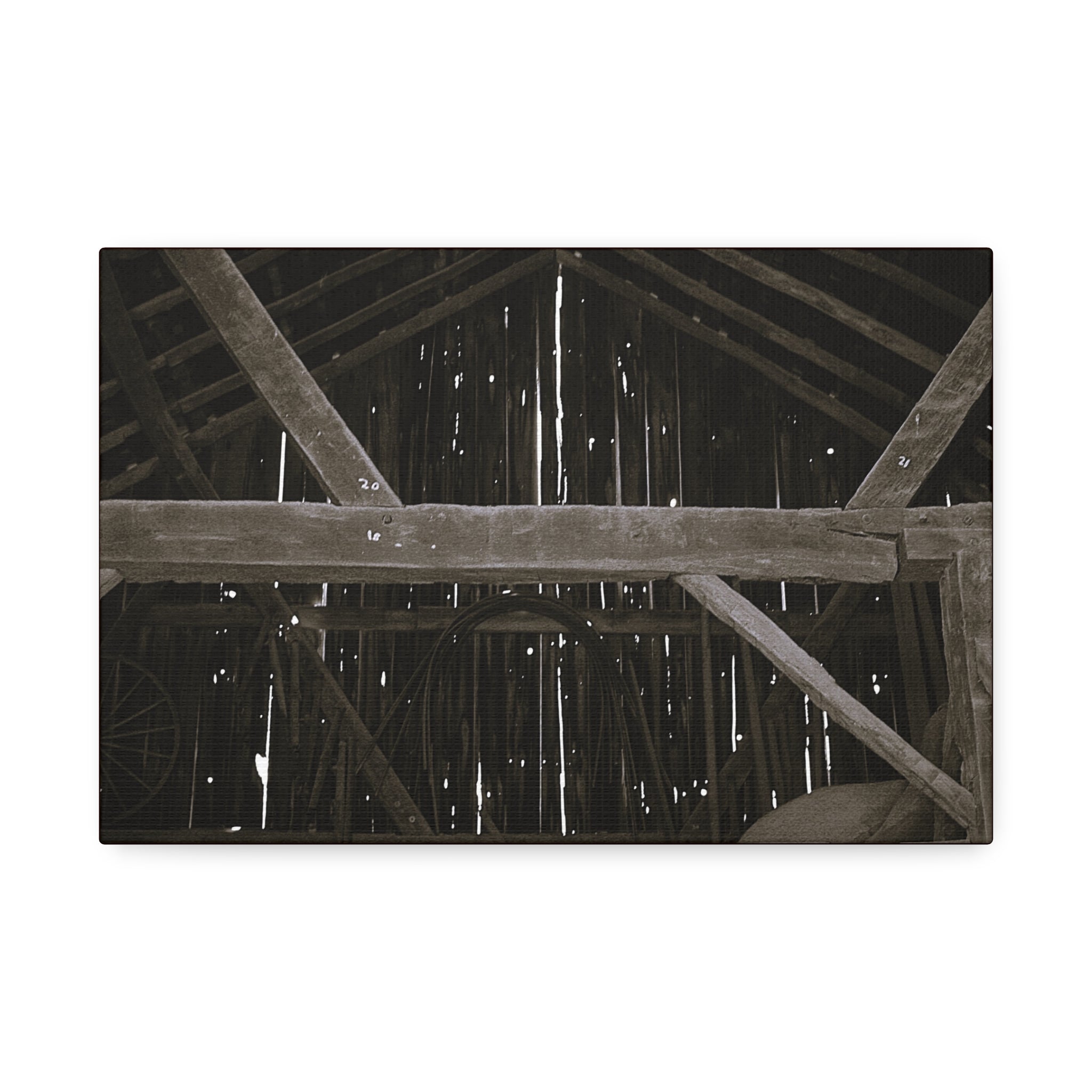 Rustic barn interior framed canvas print — moody looking-up view of weathered wooden beams and rafters with pinpoints of light, farmhouse photography wall art