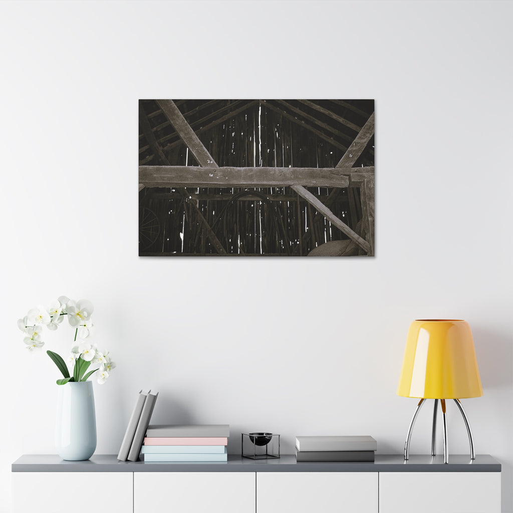 Rustic barn interior framed canvas print — moody looking-up view of weathered wooden beams and rafters with pinpoints of light, farmhouse photography wall art