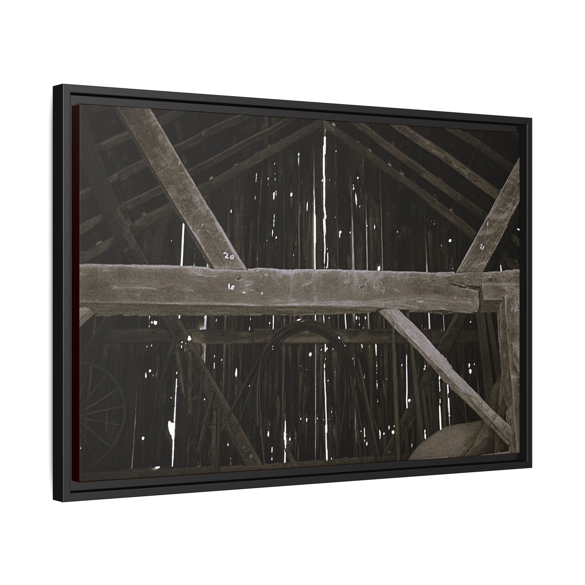 Rustic barn interior framed canvas print — moody looking-up view of weathered wooden beams and rafters with pinpoints of light, farmhouse photography wall art