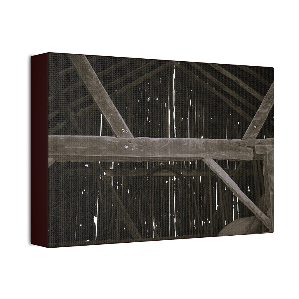 Rustic barn interior framed canvas print — moody looking-up view of weathered wooden beams and rafters with pinpoints of light, farmhouse photography wall art
